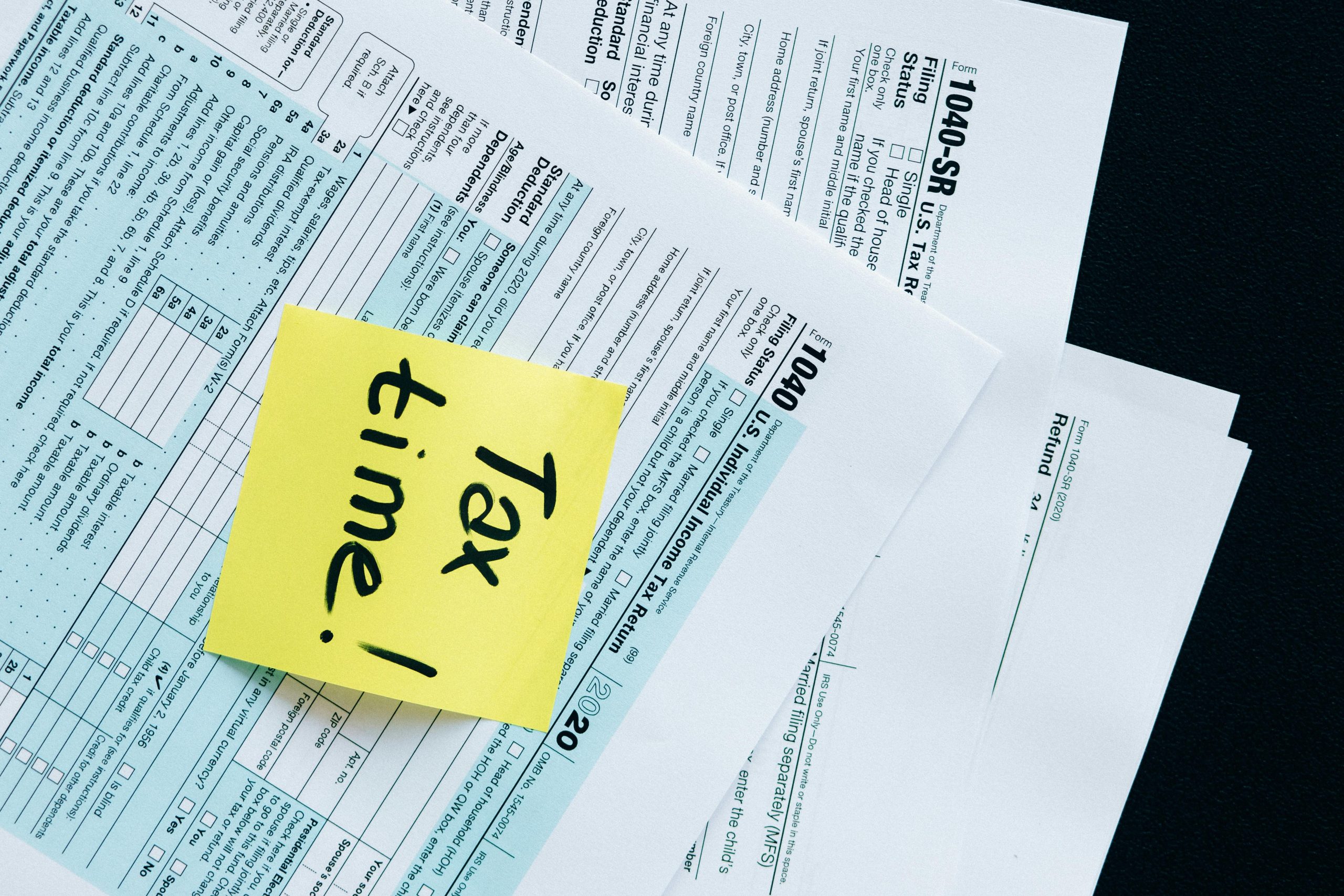 IRS 1040 tax forms with handwritten 'Tax Time!' note for filing reminder.
